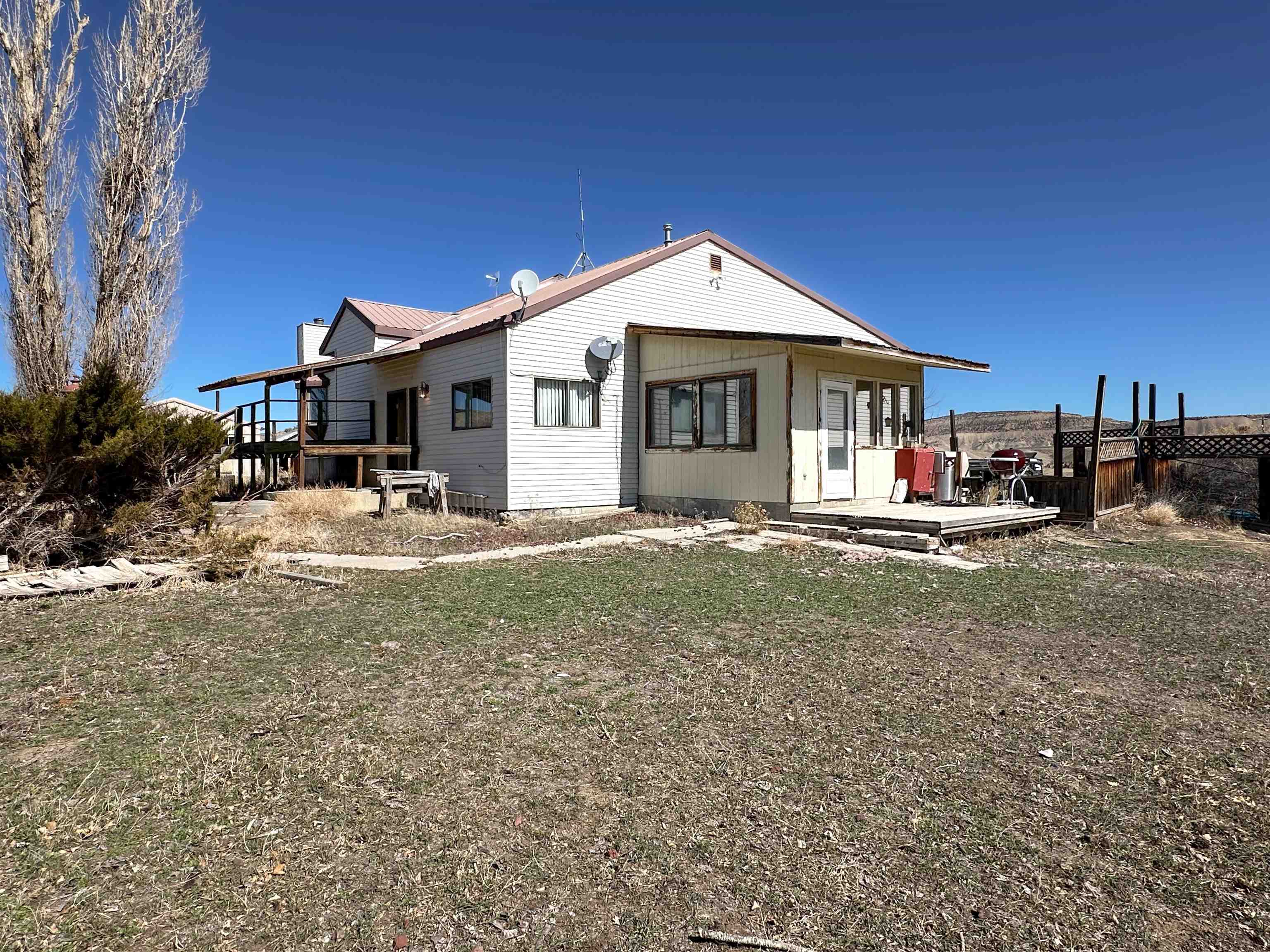 1818 County Road 46 Rangely, CO 81648 - Photo 21 of 23 a front view of a house with garden