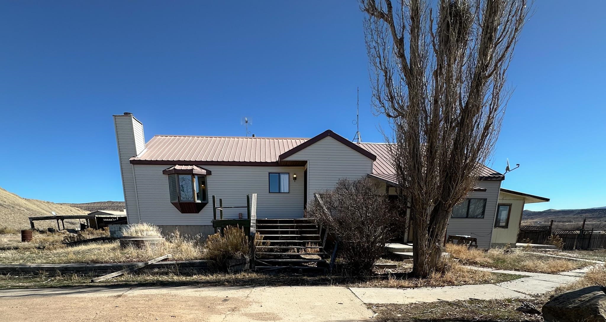 1818 County Road 46 Rangely, CO 81648 - Photo 3 of 23 a front view of a house with garden