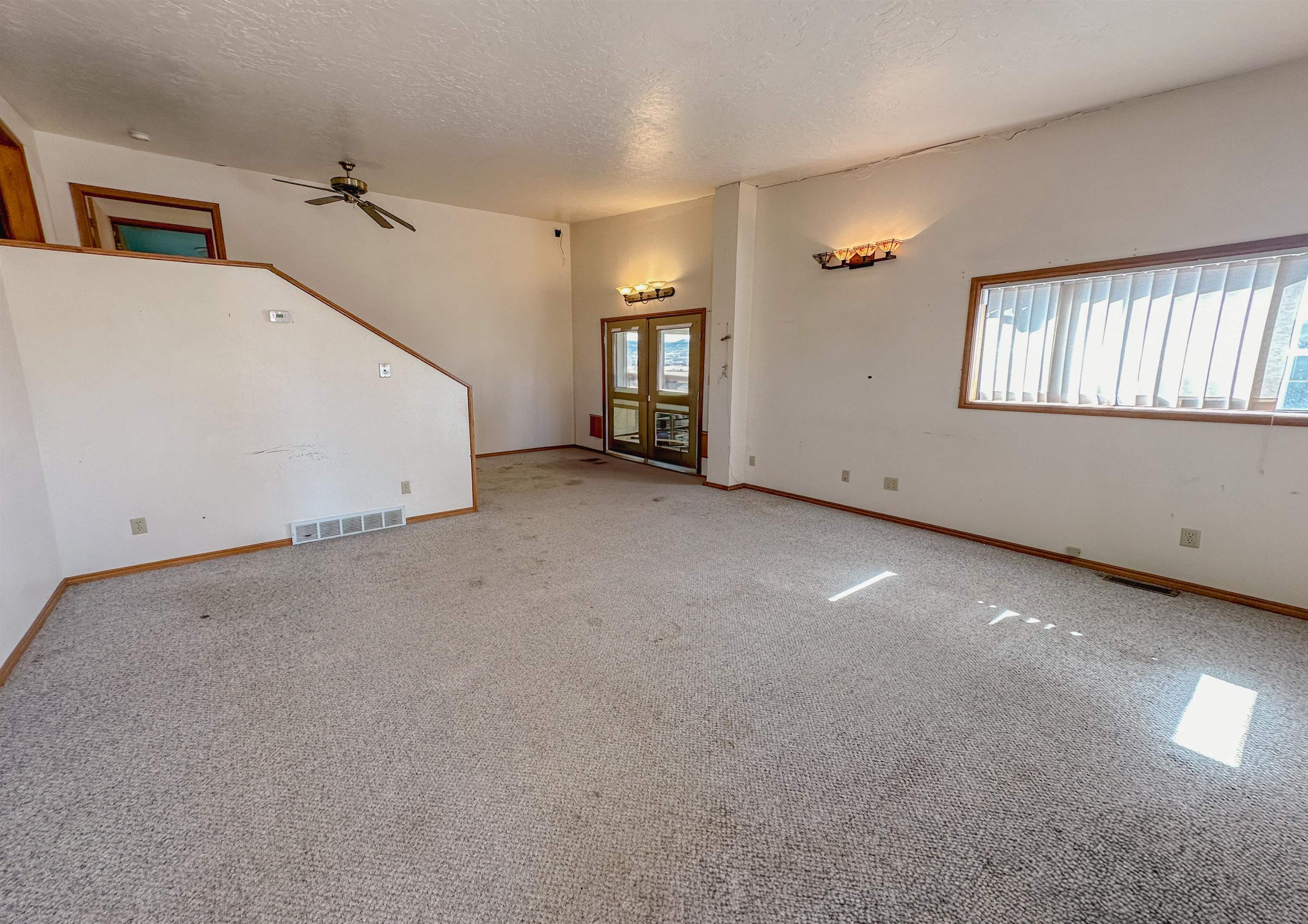 1818 County Road 46 Rangely, CO 81648 - Photo 7 of 23 a view of a livingroom with a ceiling fan and window