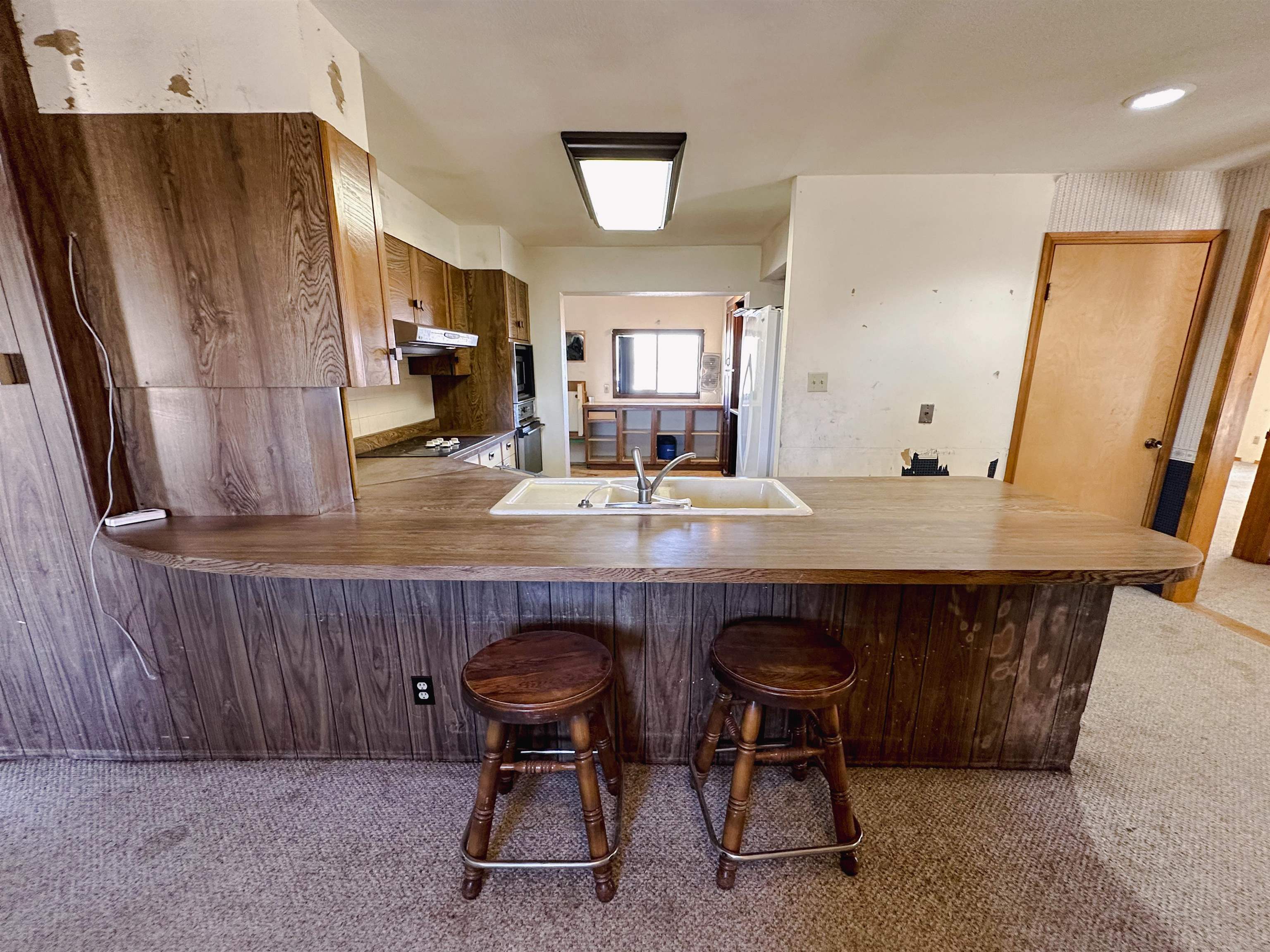 1818 County Road 46 Rangely, CO 81648 - Photo 9 of 23 a kitchen with a table chairs and refrigerator