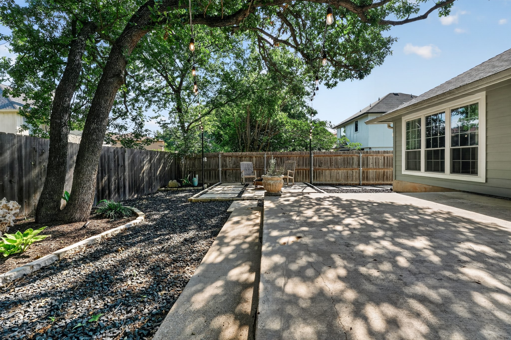 1811 Old Mill Road Cedar Park, TX 78613 - Photo 32 of 39 A private yard with mature trees and a comfortable patio area, ideal for relaxation.