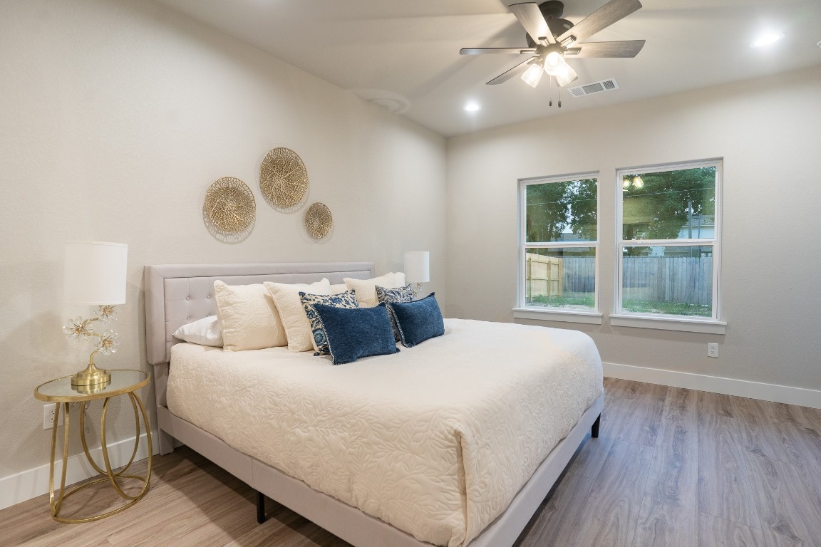 307 String Prairie Way Smithville, TX 78957 - Photo 19 of 34 Bedroom with wood finished floors, baseboards, a ceiling fan, and recessed lighting