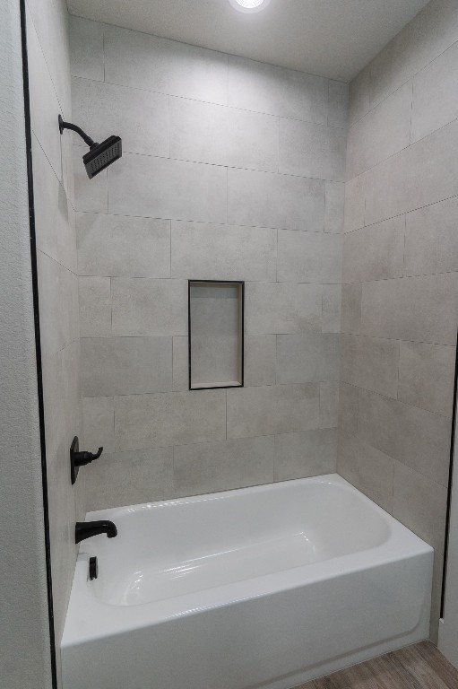 307 String Prairie Way Smithville, TX 78957 - Photo 29 of 34 Full bath featuring wood finished floors and shower / washtub combination