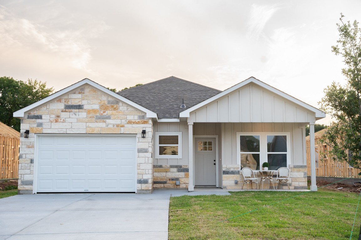 307 String Prairie Way Smithville, TX 78957 - Photo 6 of 34 View of front of property with stone siding, driveway, and roof with shingles