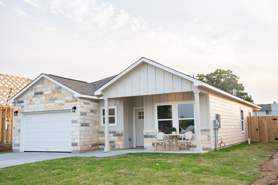 307 String Prairie Way Smithville, TX 78957 - Photo 7 of 34 View of front of house featuring an attached garage, stone siding, roof with shingles, and driveway