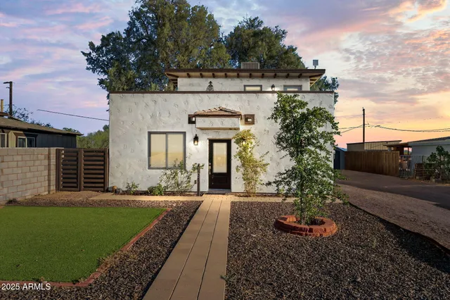 a front view of a house with garden