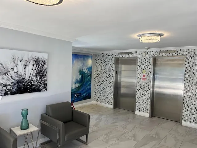 a view of a refrigerator in kitchen and a livingroom
