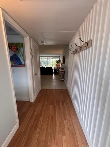 a living room with a large window and a wooden floor