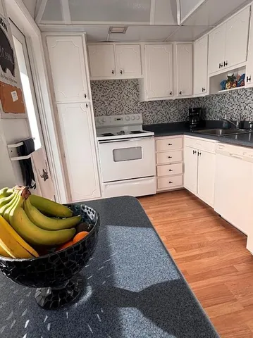 a view of a hardwood floor and a window in an empty room