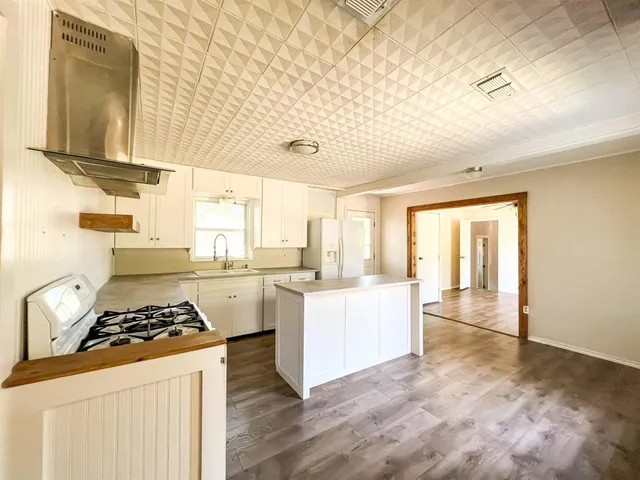 a kitchen with a stove a sink and a refrigerator