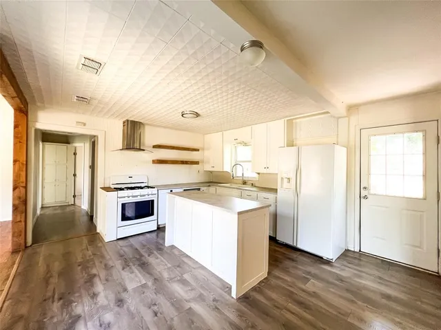 a kitchen with a stove a sink and a refrigerator