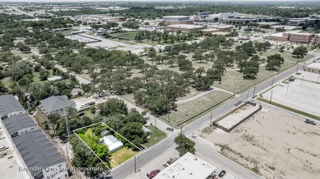 a view of a livingroom with wooden floor and kitchen space