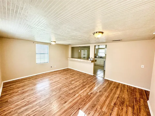 a view of a living room with kitchen island furniture and a kitchen view