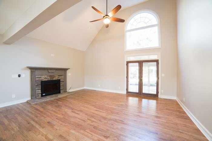 1925 Jesse Cronic Road Braselton, GA 30517 - Photo 13 of 58 an empty room with wooden floor fan and windows