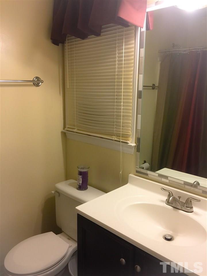 3422 Freeman Road Durham, NC 27703 - Photo 14 of 15 a bathroom with a sink toilet and shower