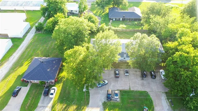 an aerial view of multiple houses with yard