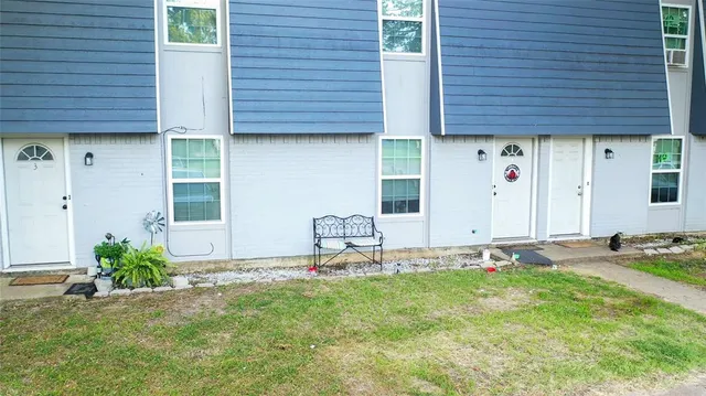 a backyard of a house with table and chairs