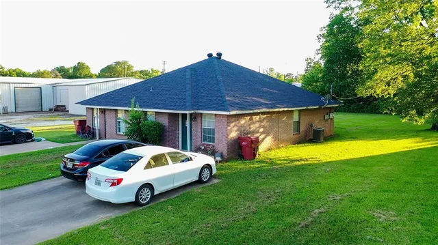 a front view of house with outdoor space and swimming pool
