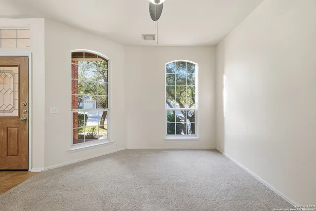 an empty room with windows and closet