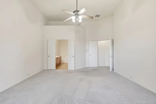 a view of a room with a ceiling fan and a chandelier fan