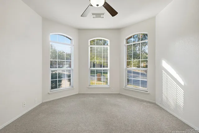 an empty room with windows and closet