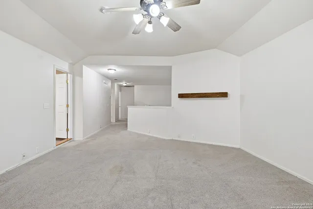 a view of a chandelier fan and fire place