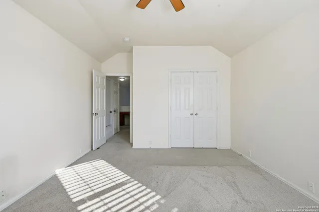 a view of a bedroom with wooden floor and bathroom
