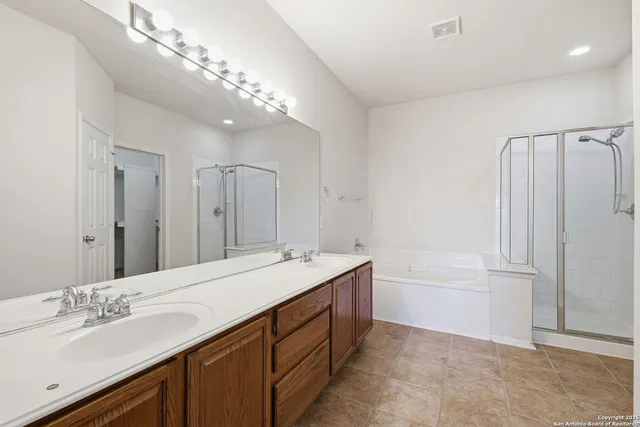 a spacious bathroom with a double vanity sink mirror and double