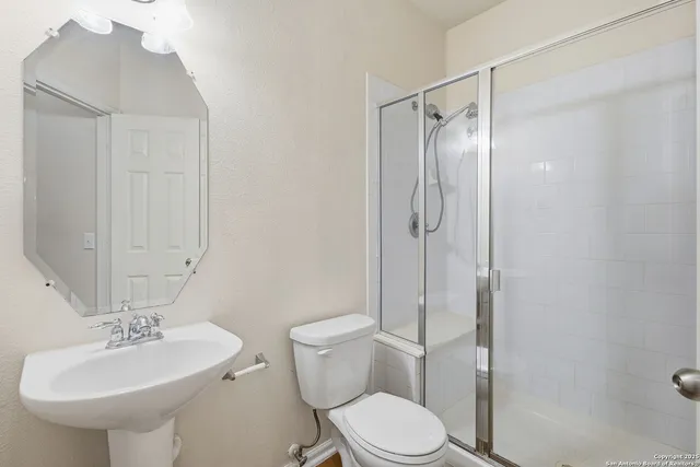 a bathroom with a sink toilet and shower