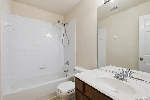 a bathroom with a sink toilet vanity and shower