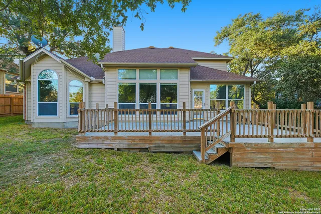 a view of a house with a yard and deck