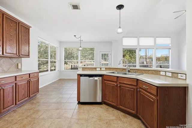 a large kitchen with kitchen island granite countertop a sink and a large window