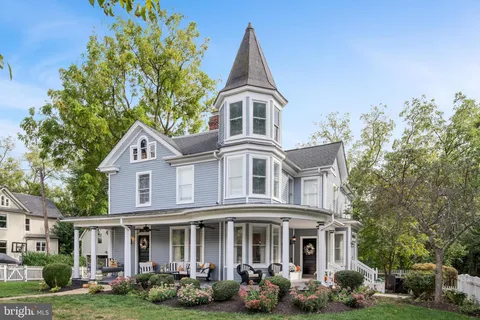 front view of a brick house with a yard