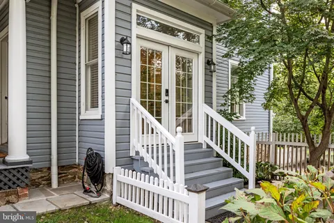 a view of an entryway with wooden floor fireplace and a window