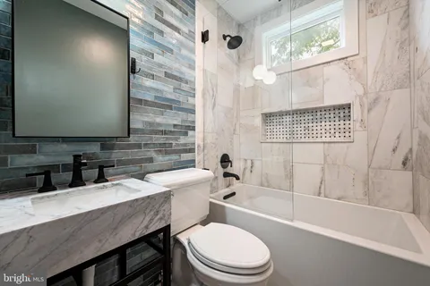 a spacious bathroom with a shower a sink and a mirror