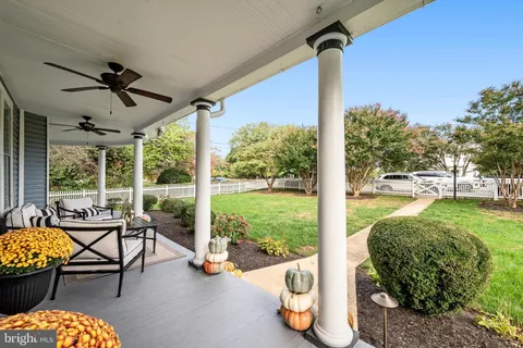 a view of a porch with furniture and garden
