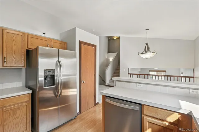 a kitchen with stainless steel appliances a refrigerator and a stove