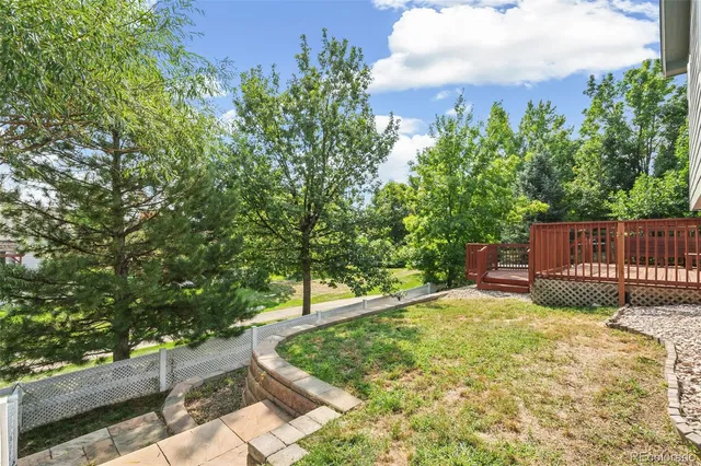 a view of a backyard with wooden fence