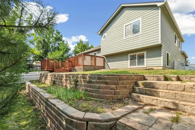 a view of house with backyard