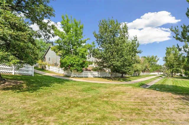 a view of a house with a yard and a garden