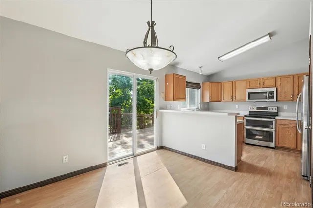 a kitchen with stainless steel appliances a refrigerator and a stove top oven