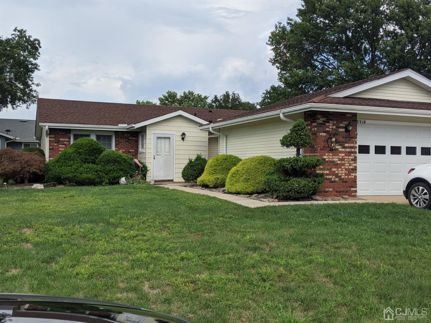 230 Convent Road, Unit A Monroe Township, NJ 08831 - Photo 1 of 22 a view of a yard in front of a house with plants and large tree