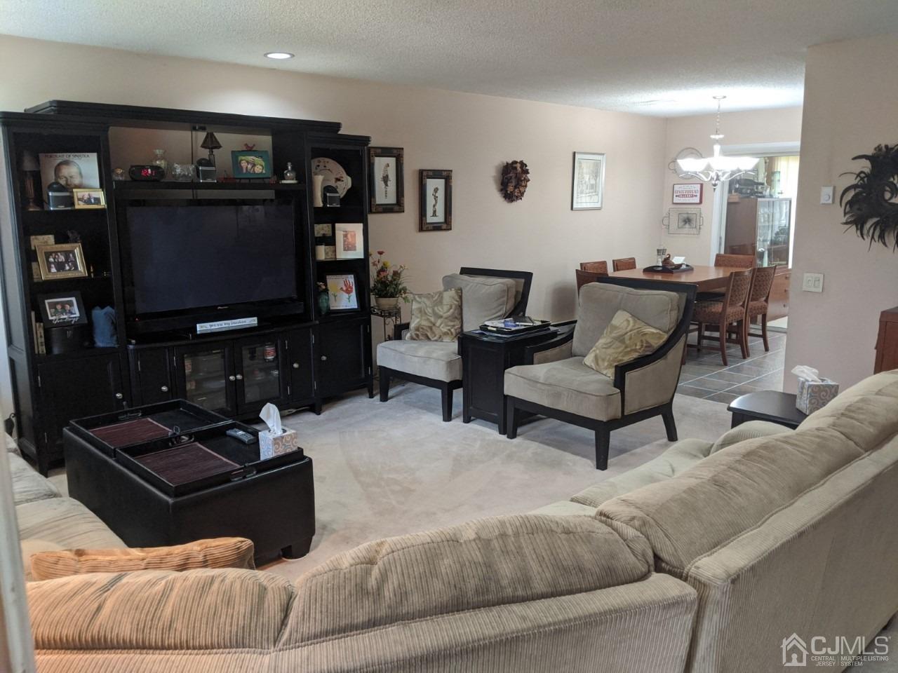 230 Convent Road, Unit A Monroe Township, NJ 08831 - Photo 5 of 22 a living room with furniture and a flat screen tv