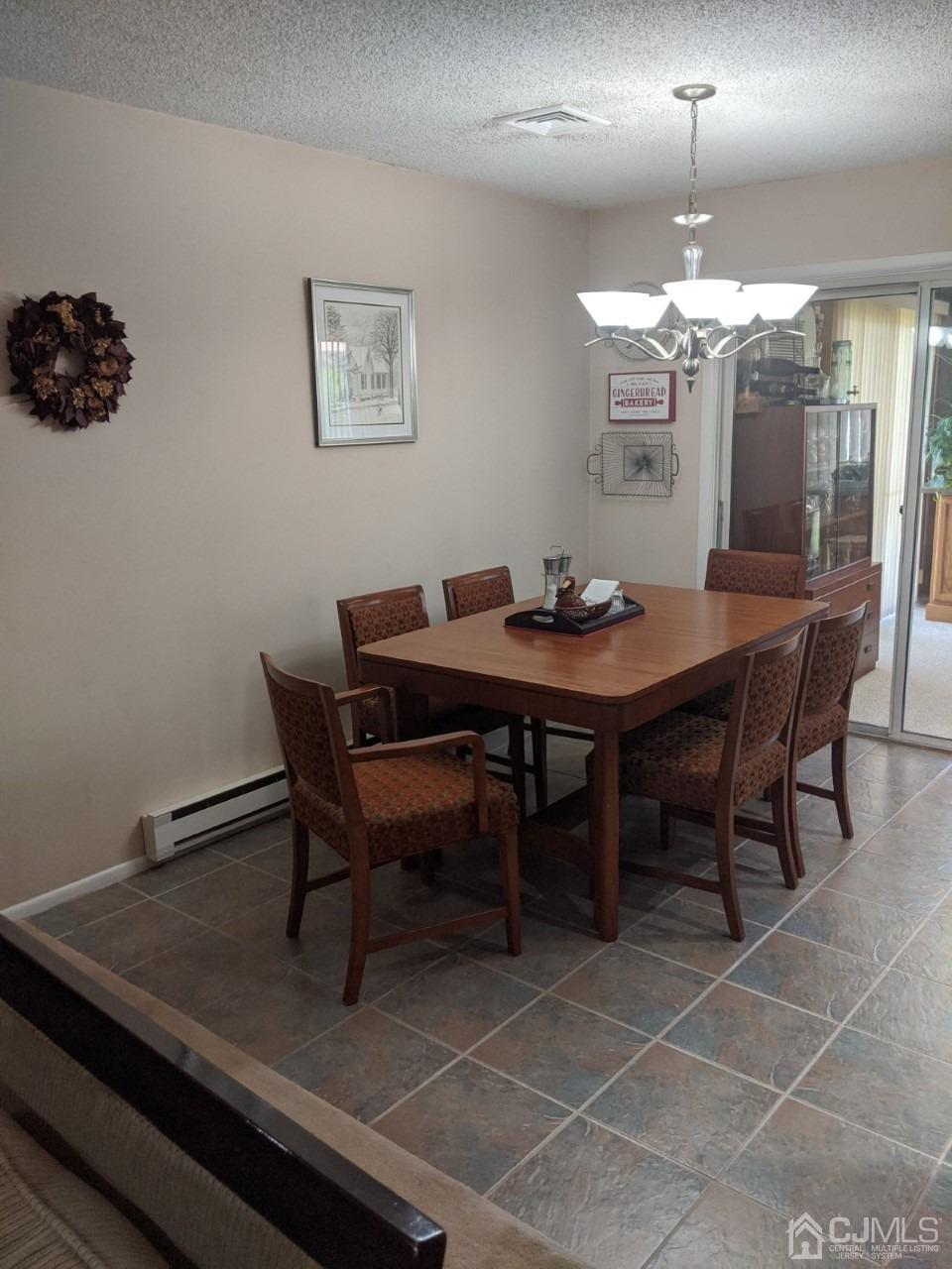 230 Convent Road, Unit A Monroe Township, NJ 08831 - Photo 6 of 22 a view of a dining room with furniture and chandelier