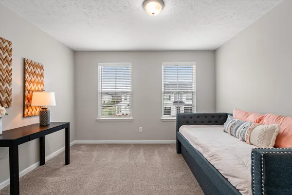a bedroom with a bed and window
