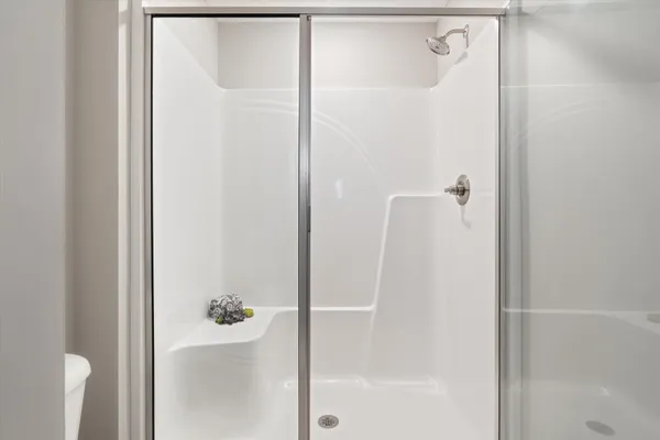 a bathroom with a glass shower door