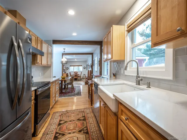a kitchen with counter top space a sink cabinets and appliances