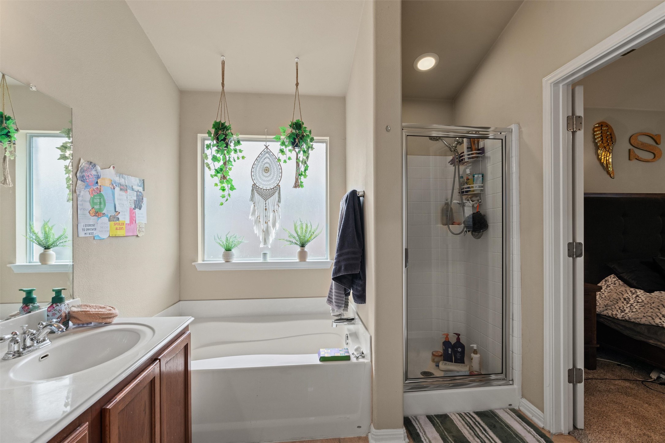 11917 Lansdowne Road Austin, TX 78754 - Photo 12 of 20 This bathroom offers a large soaking tub and a separate glass-enclosed shower for ultimate relaxation.