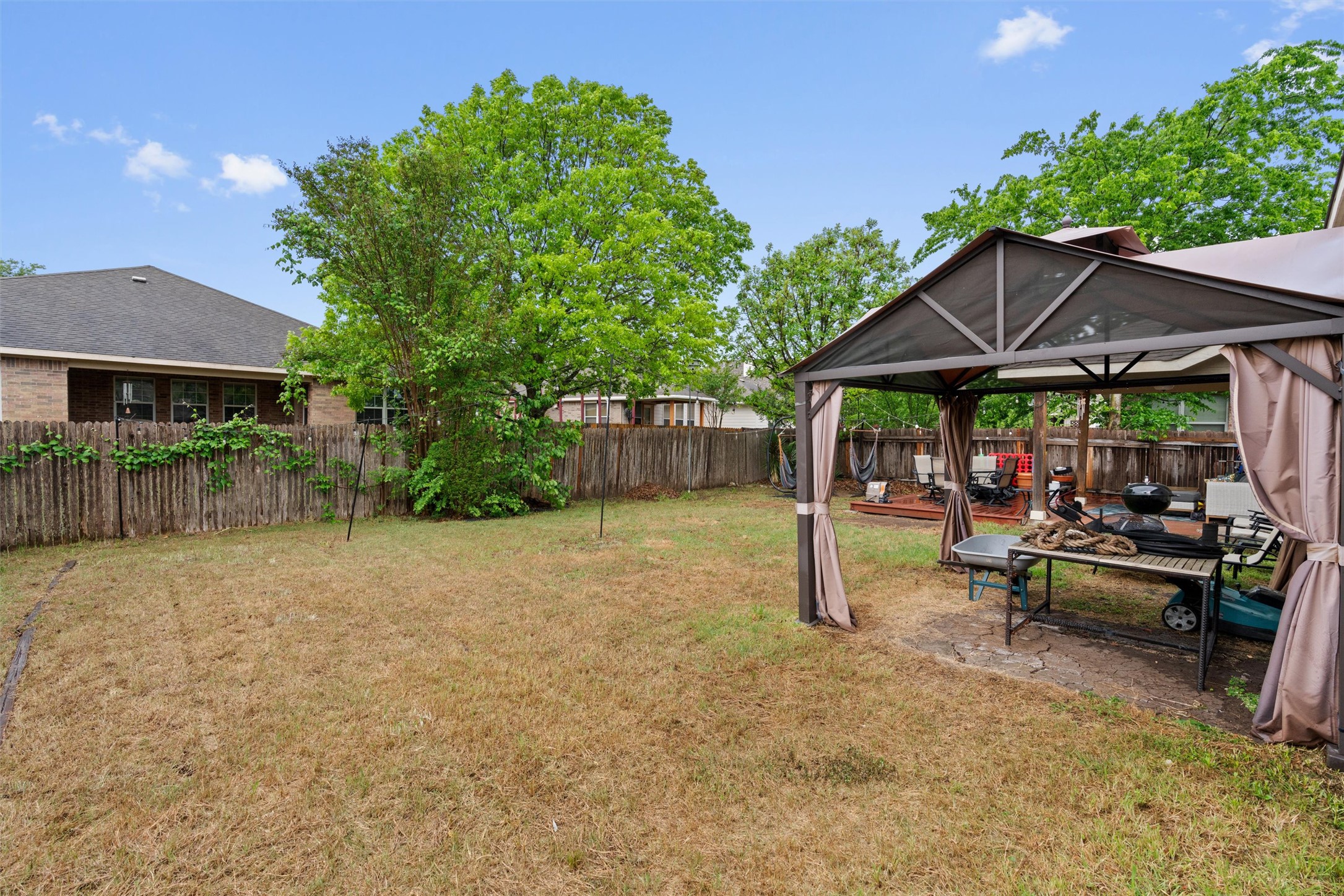11917 Lansdowne Road Austin, TX 78754 - Photo 18 of 20 This spacious yard features a gazebo, perfect for outdoor gatherings and relaxation.