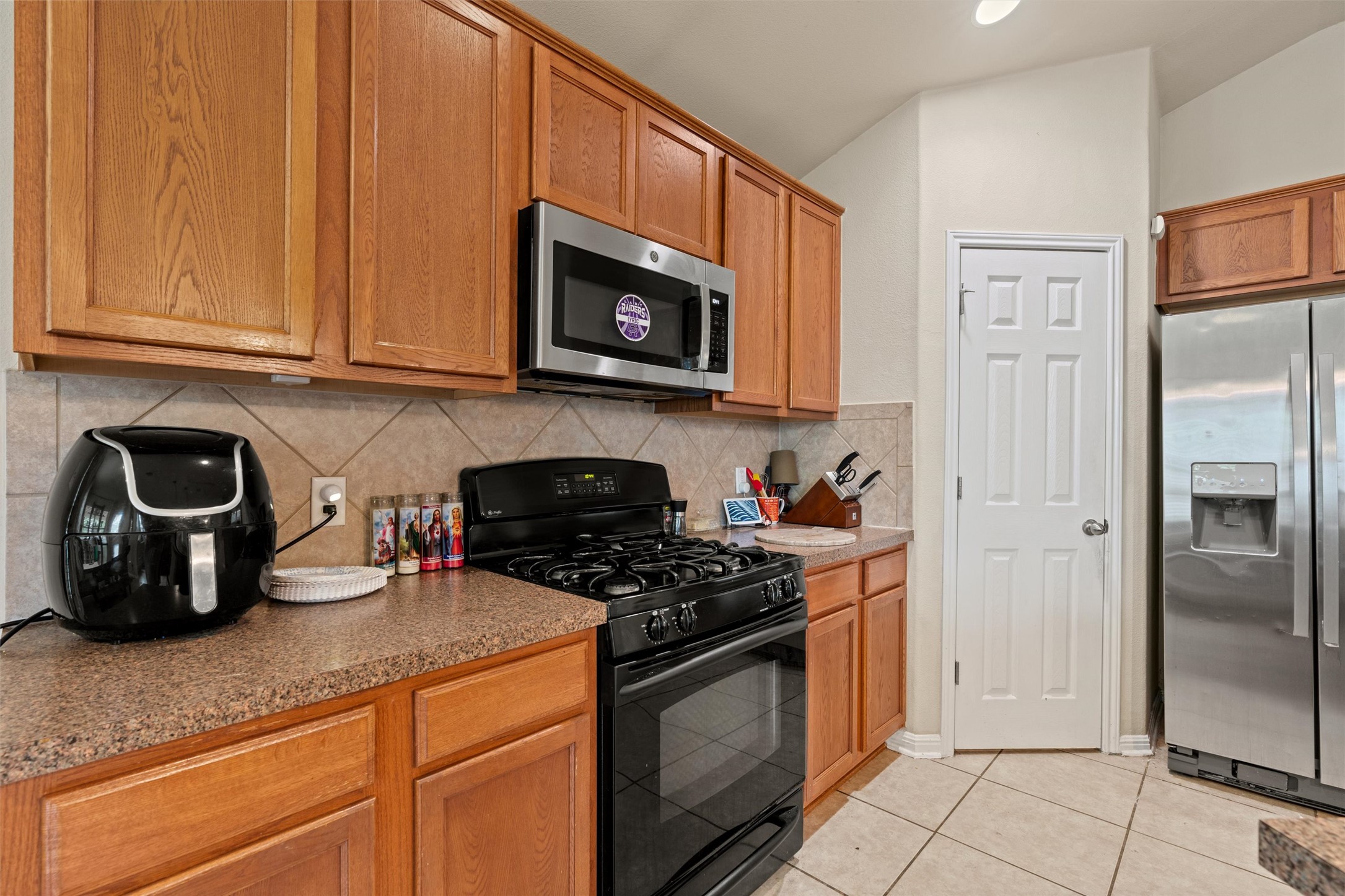11917 Lansdowne Road Austin, TX 78754 - Photo 7 of 20 This functional kitchen features warm wood cabinetry and a suite of stainless steel appliances.